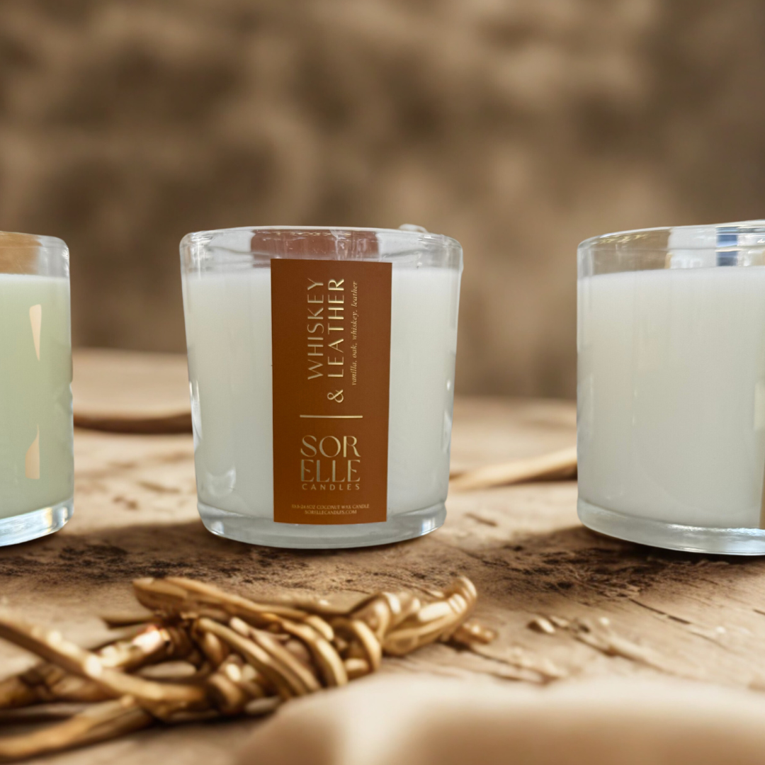 15 oz and 25 oz whiskey leather clean burning coconut wax candle in clear glass vessel with gold foil label