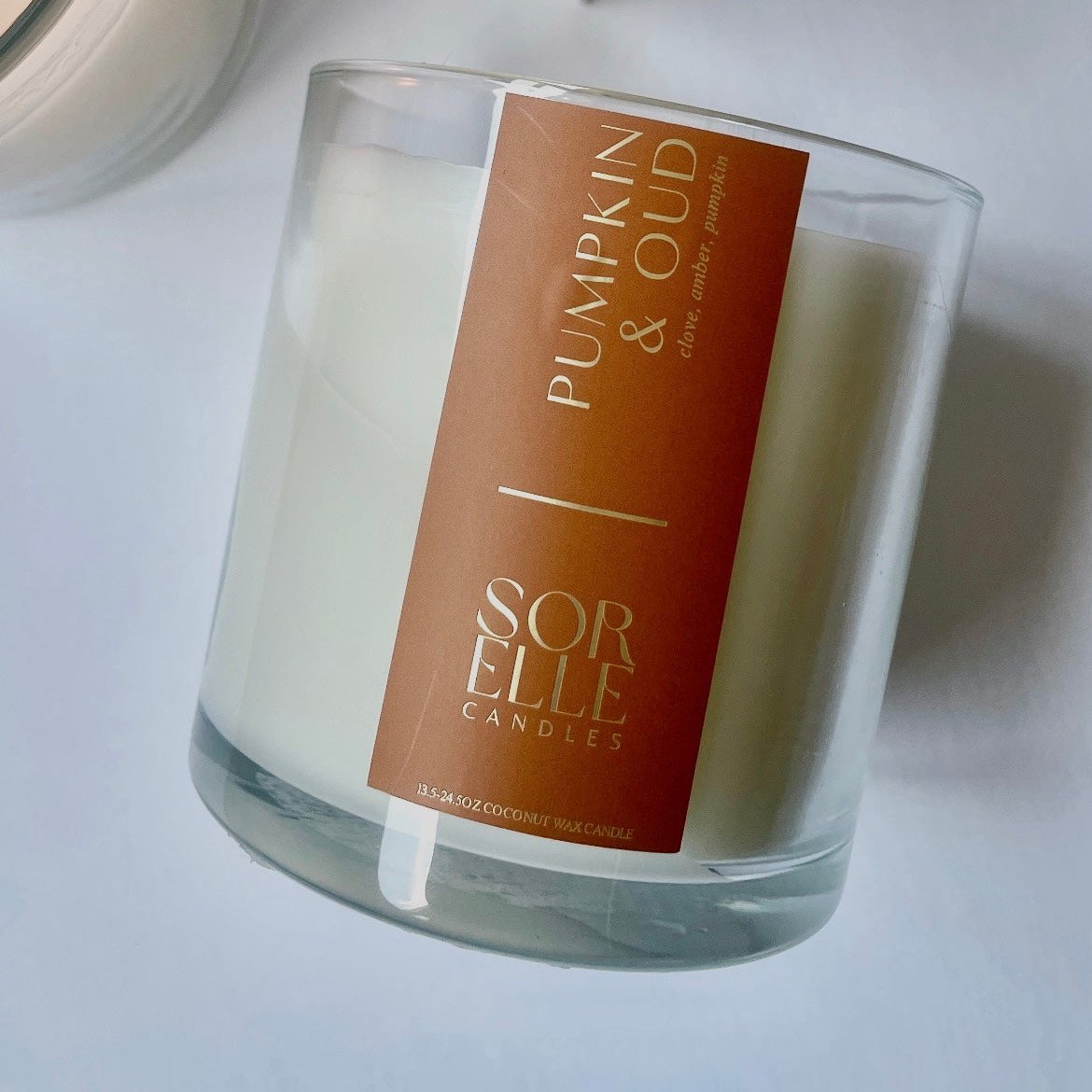 Hand-poured Pumpkin Oud coconut wax candle with clove, amber, and pumpkin notes — fall scent in glass jar