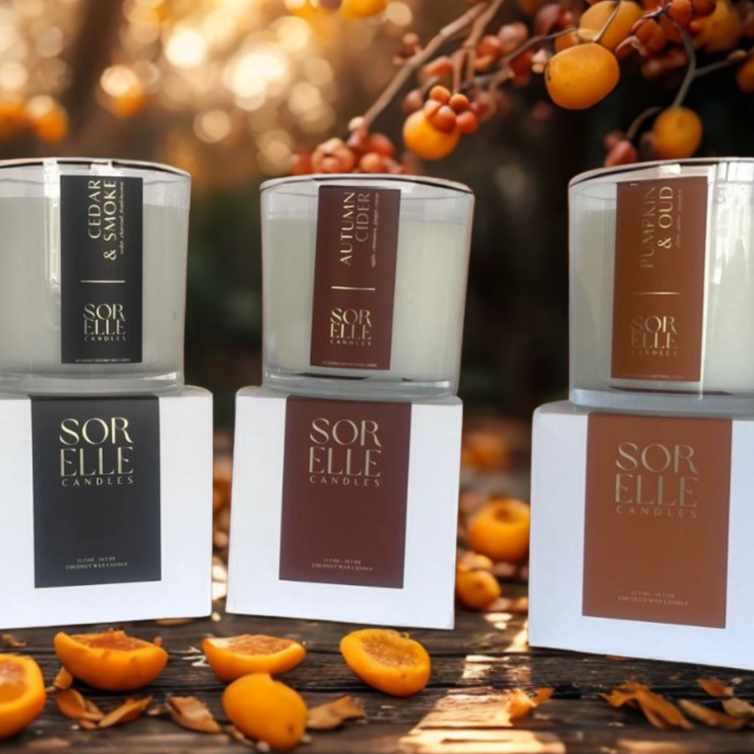 Fall coconut soy wax candle in glass jar styled with apples, fall spices, and cozy seasonal decor