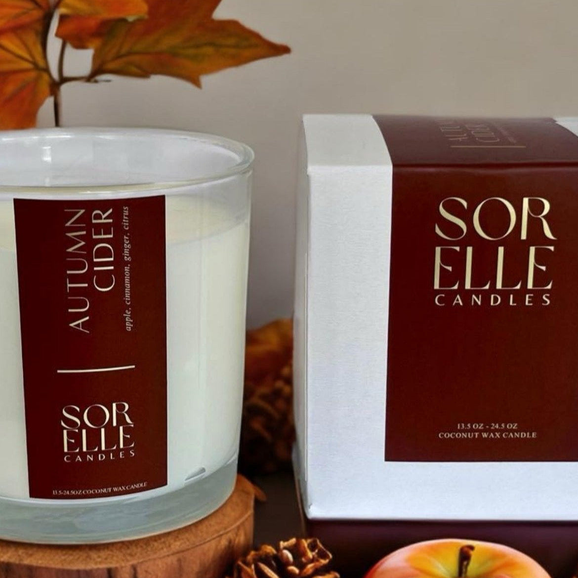 Autumn Cider candle in glass jar styled with apples, fall spices, and cozy seasonal decor