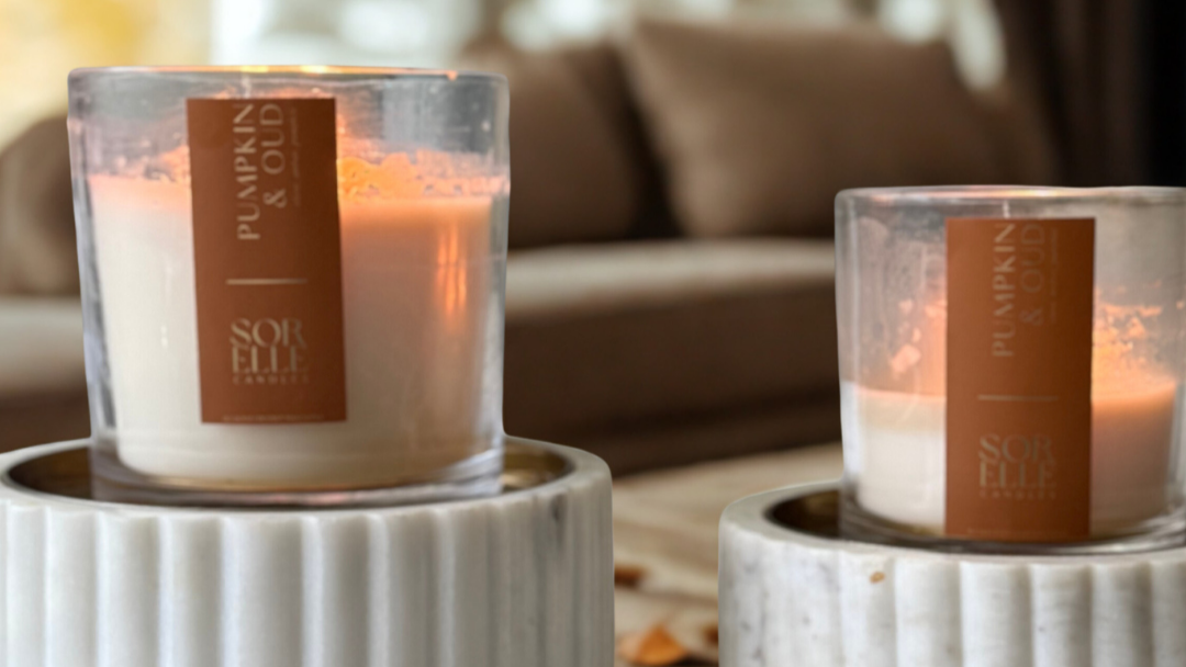 Hand-poured Pumpkin Oud coconut soy wax candle with clove, amber, and pumpkin notes — fall scent in amber glass jar
