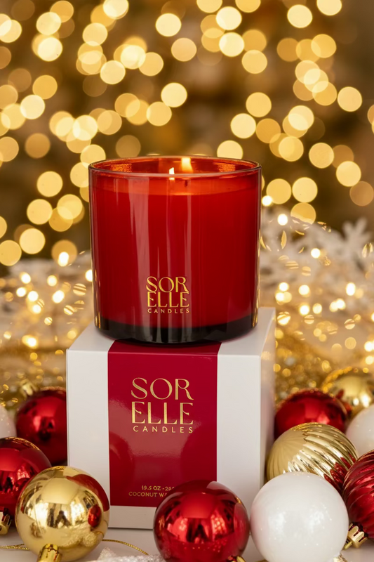 Red glass Christmas candle, gold sorelle logo. Coconut soy wax christmas candle